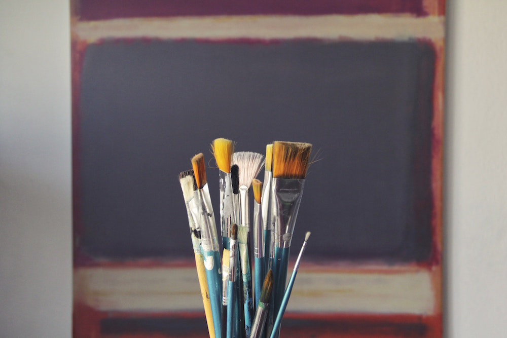 a bucket of paintbrushes