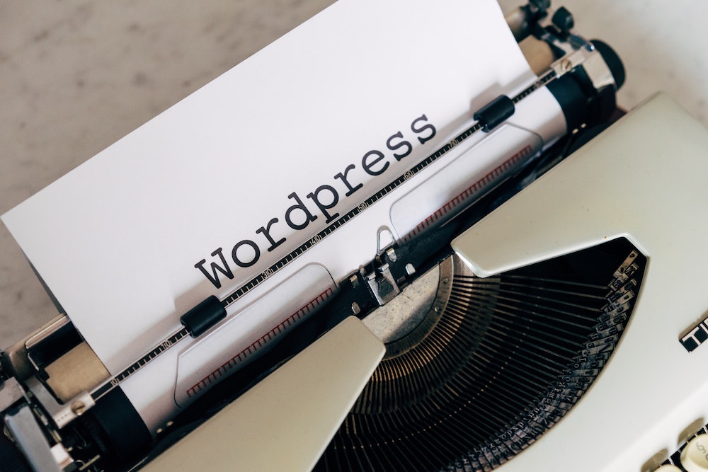 Benefits of WordPress - a typewriter typing out the word WordPress