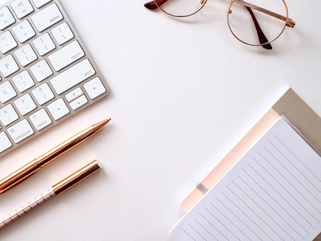 your personal brand - desk with keyboard, notepad, and pens