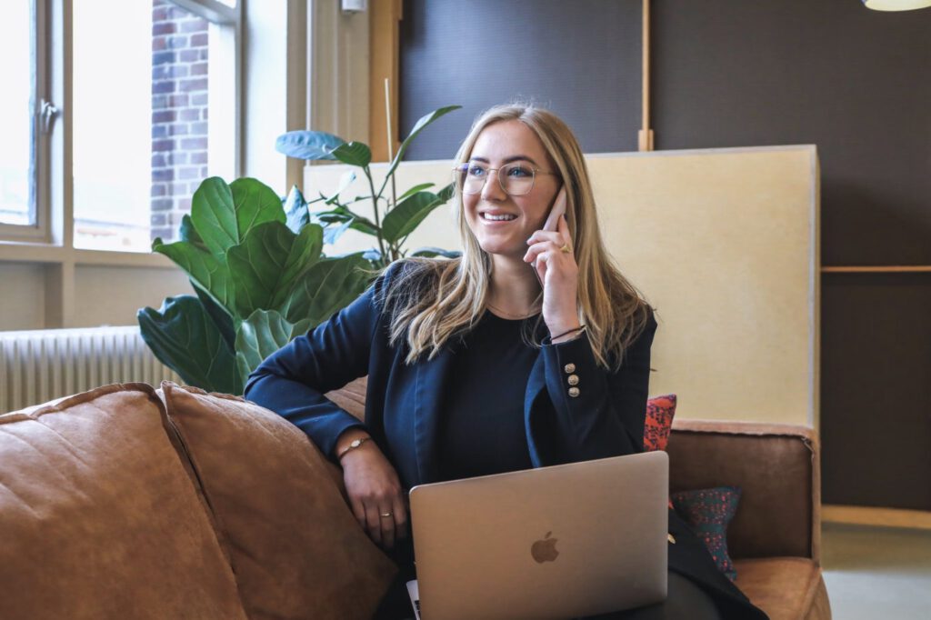 woman talking on the phone - successful first call with a prospective client