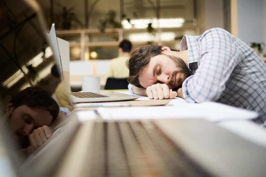 take care of yourself during busy times - man fell asleep at computer