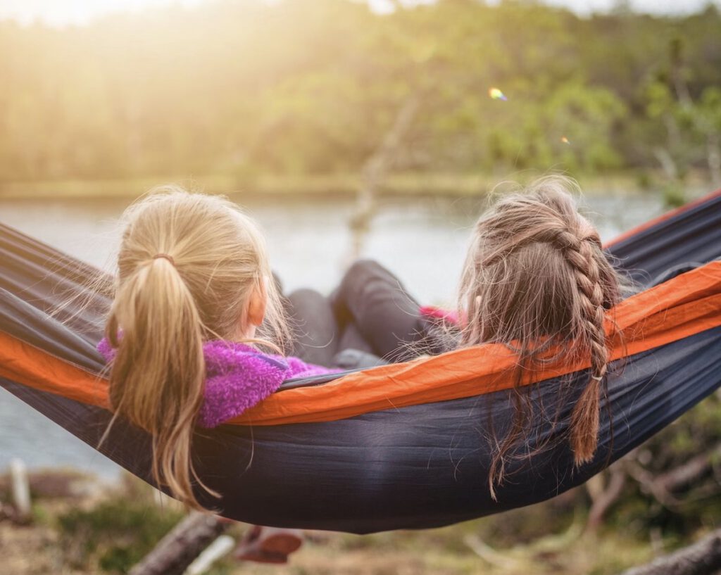 two girls relaxing in a hammock