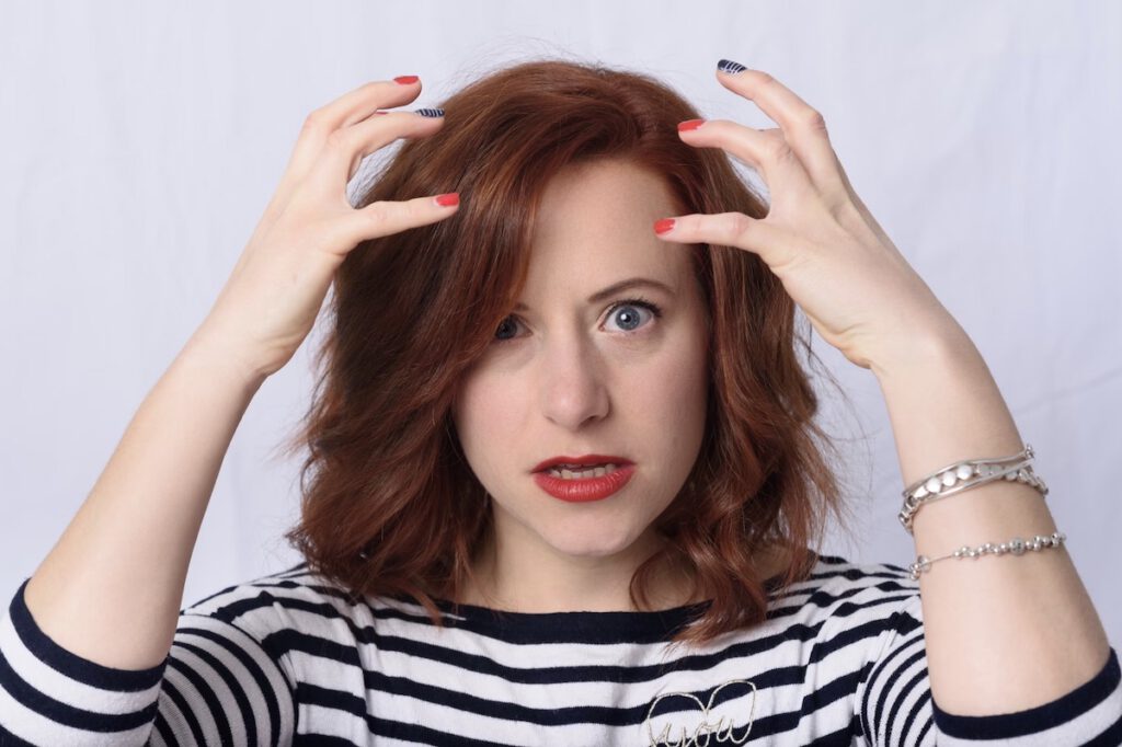 woman waiting impatiently with her hands around her head