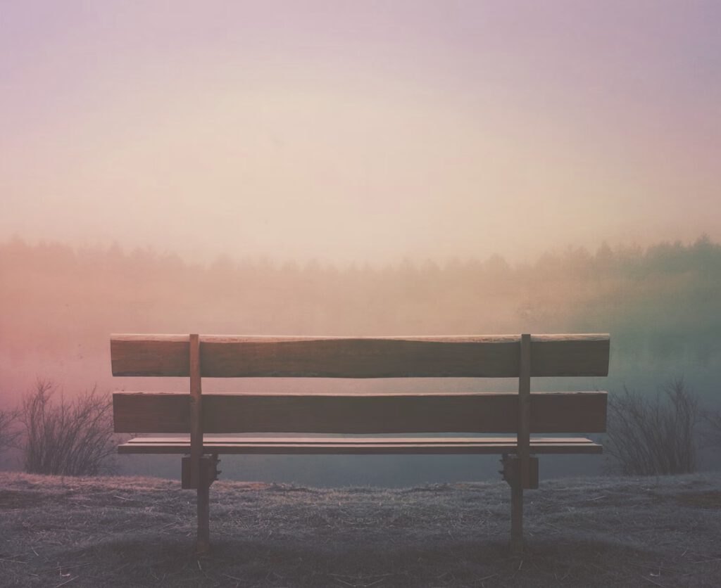 an empty bench at sunrise