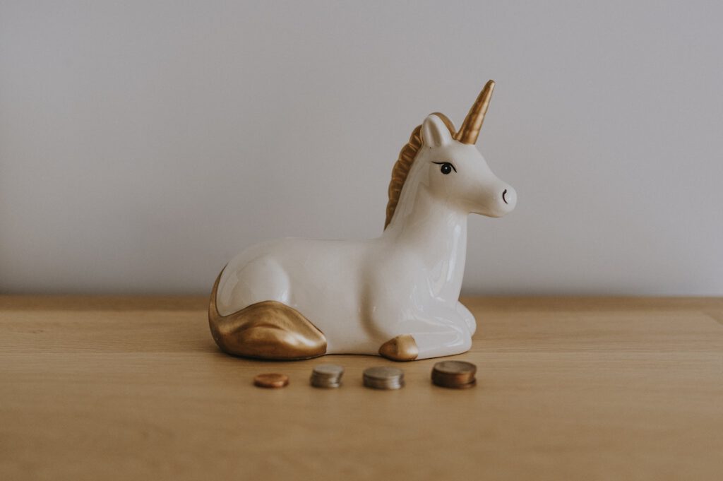 unicorn piggy bank with coins