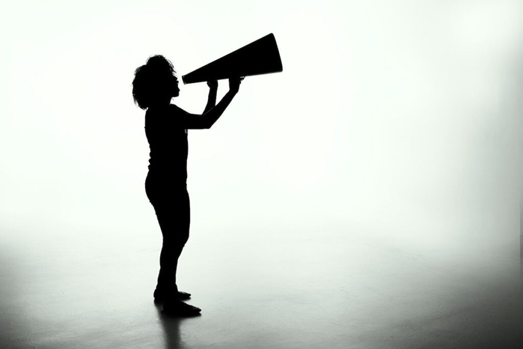 woman holding a loudspeaker