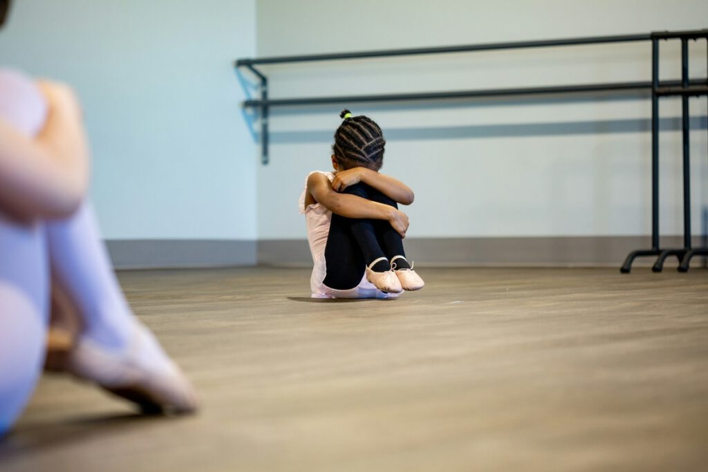 little girl looking nervous in a ballet studio