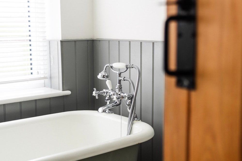 bathroom door and a bath tub