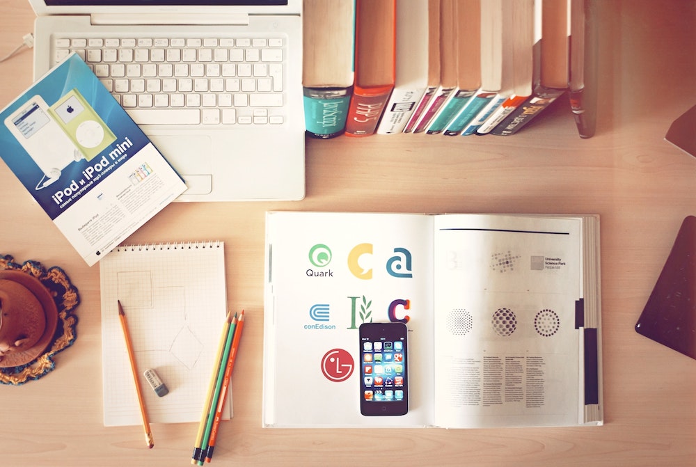 a desk with book, pencil, and task list