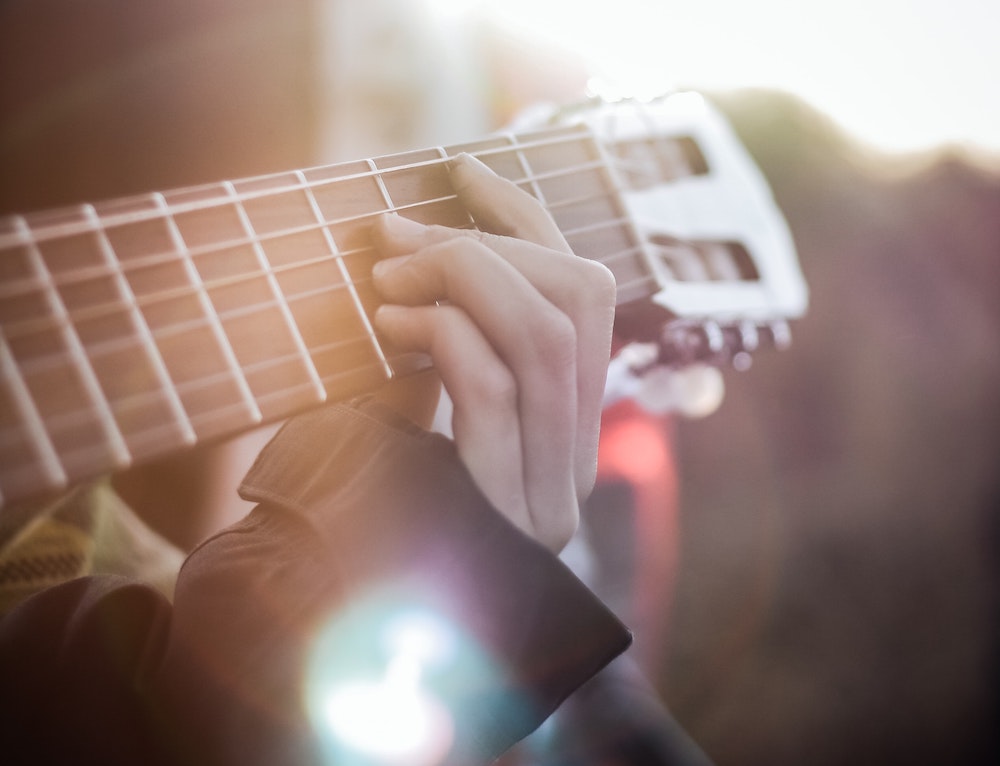 fun ways to cure the winter blues: hands playing a guitar