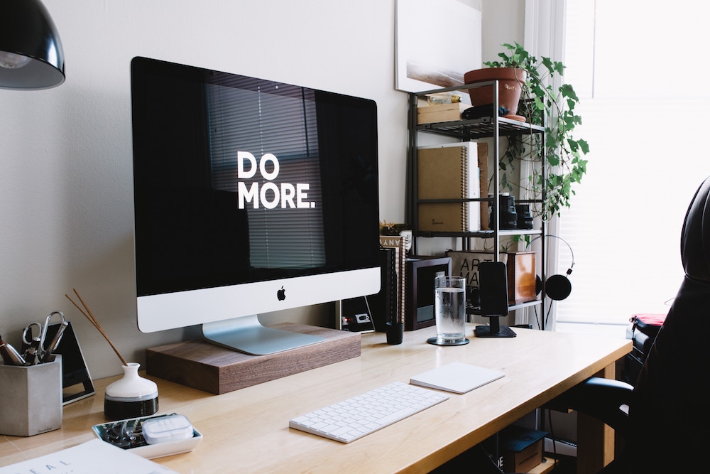 Home Office Ideas for Her: - an iMac on a fancy desk with plants and artwork all around