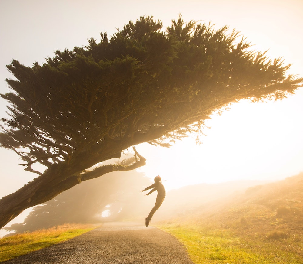 how to get motivated - person jumping in a field