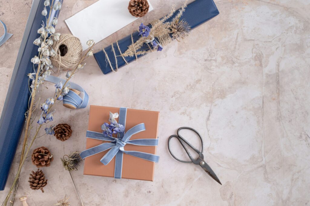 wrapping a gift with scissors and flowers